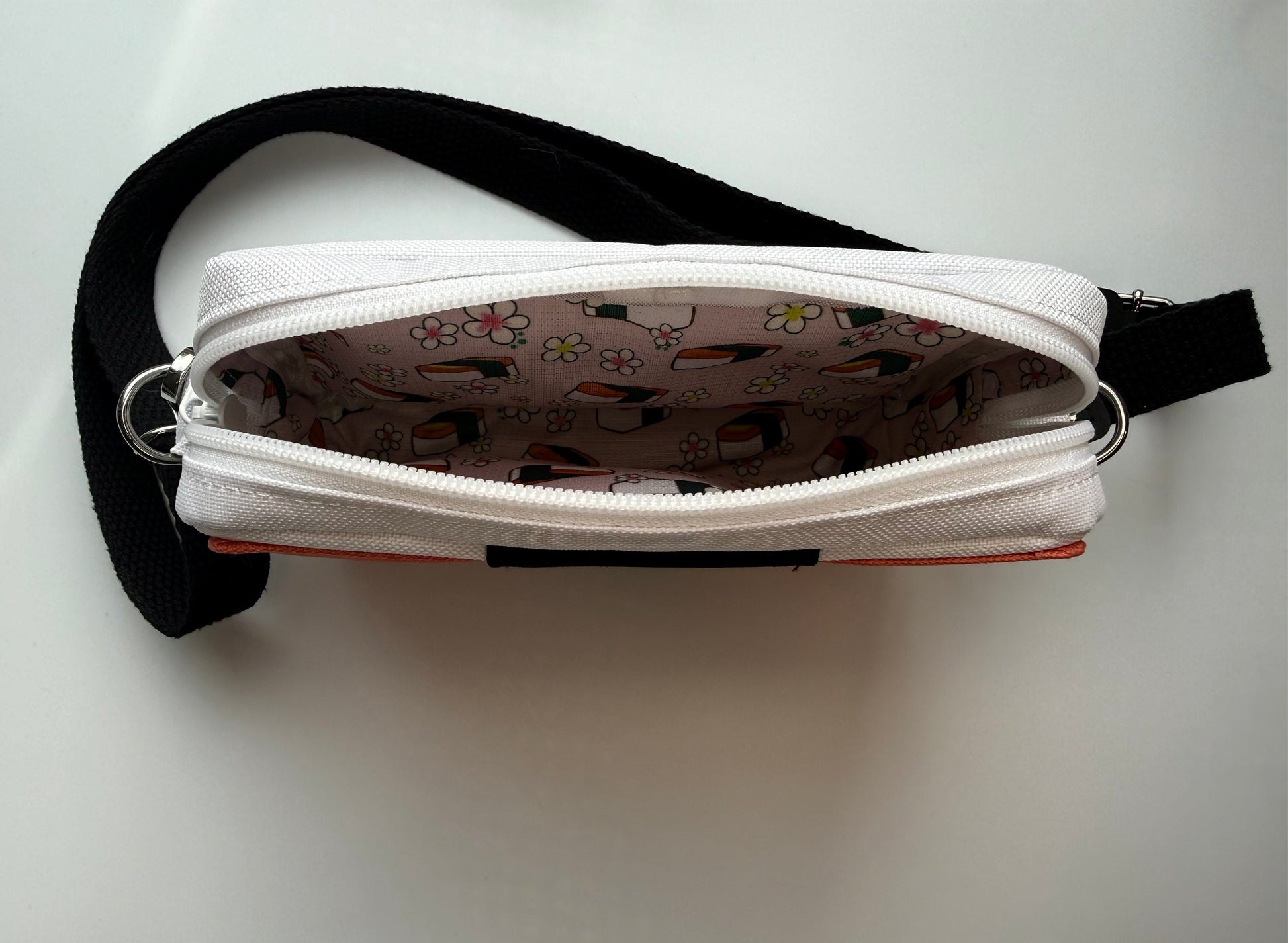 Interior of a handbag printed with spam musubi and flowers on a pink background