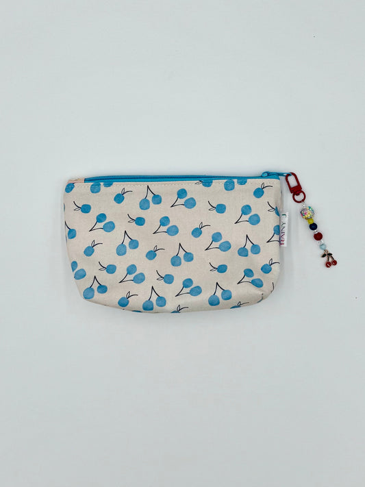 cherry print cosmetic pouch in blue with a kawaii charm