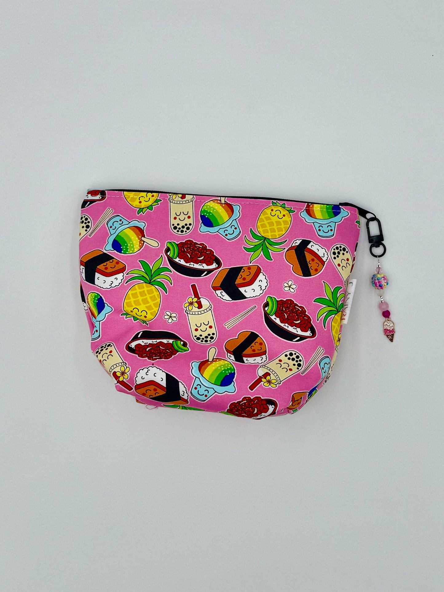 cosmetic pouch with Hawaiian food kawaii print on a bright pink background