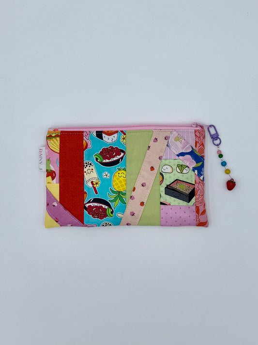 kawaii toiletry bag with Hawaiian food and sushi print and a strawberry charm