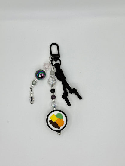 Handmade kimbap charm with rice and seaweed design, front vie