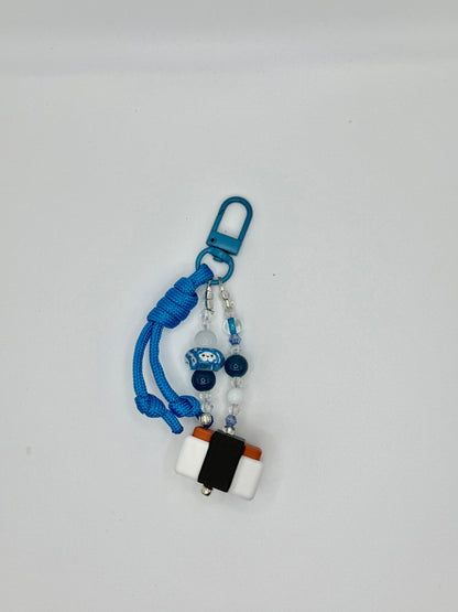 Handmade Spam musubi charm with seaweed wrap and rice details, front view