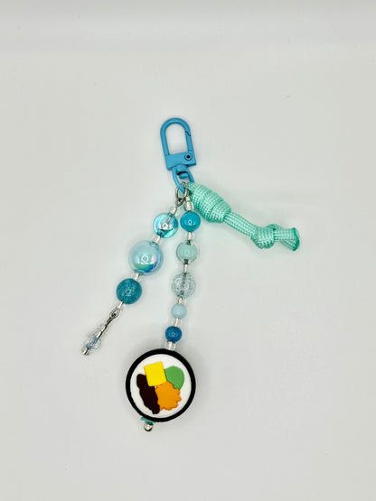 Handmade kimbap charm with rice and seaweed design, front view