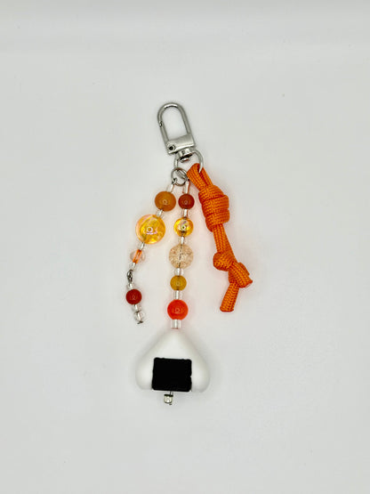 Handmade onigiri rice ball charm with seaweed wrap detail, front view