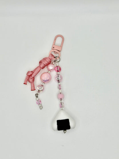 Handmade onigiri rice ball charm with seaweed wrap detail, front view.