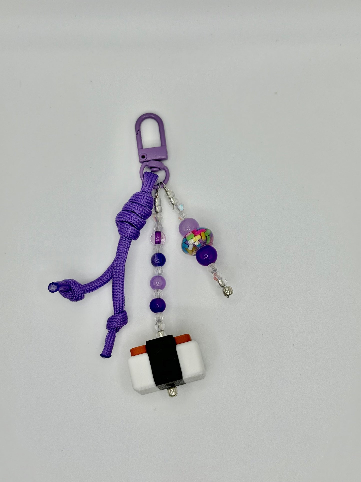 Handmade Spam musubi charm with seaweed wrap and rice details, front view