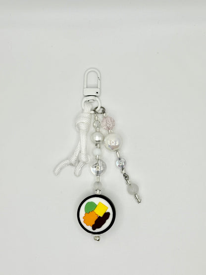 Handmade kimbap charm with rice and seaweed design, front view